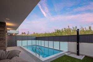 a swimming pool on the roof of a house at VillaSaints I Private Pool Villas, Walk to Beach, BBQ in Chania Town