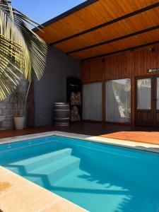 a swimming pool in a house with a wooden ceiling at Aerohouse in Posadas