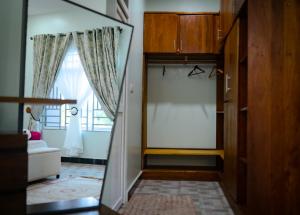 a mirror in a room with a window at Victory Homes in Dar es Salaam