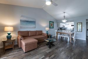 a living room with a couch and a table at Palmetto 306 in Orange Beach
