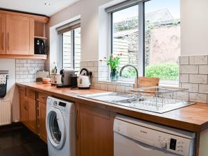 a kitchen with a sink and a dishwasher at Summerville Cottage in Kirkby Stephen +11 photos