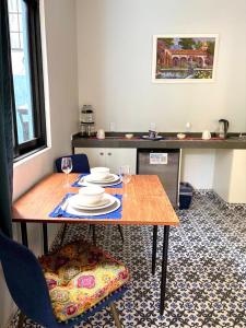 a dining room table with plates and wine glasses on it at Garden of Dreams Boutique Hotel in Ajijic