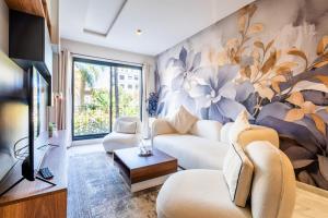a living room with a flower mural on the wall at Résidence Cerezo - Palmier in Maarif