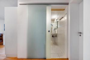 a bathroom with a toilet and a sink in a room at Ferienwohnung Lilly in Hofgeismar +18 photos