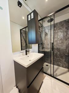 a bathroom with a sink and a shower at Sea view Anika by Vellaris, Luxury Mobile Home in Mali Lošinj