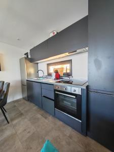 a kitchen with a sink and a stove at Sea view Anika by Vellaris, Luxury Mobile Home in Mali Lošinj