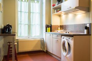 a kitchen with a washing machine and a window at Appartement Le Buffon in Dijon