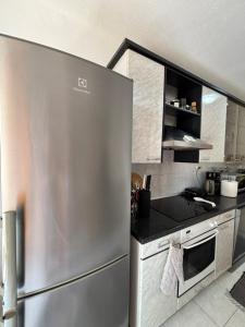 a kitchen with a stainless steel refrigerator at Apartment Marevic in Klek