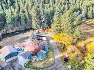 an aerial view of a large house with aestead at Riverside Tiny Home with Dynamite Views in Bailey +12 photos