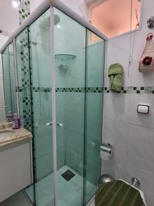 a glass shower in a bathroom with a sink at Sobrado na Cidade de Socorro in Socorro