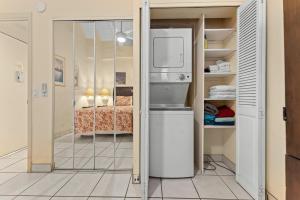 a kitchen with a refrigerator in a room at Maui Vista 2422 in Kihei