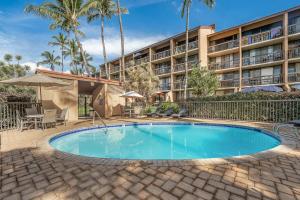 a swimming pool in front of a hotel at Maui Vista 2422 in Kihei