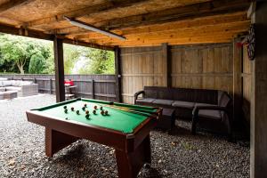 a pool table in a backyard with a bench at Northumberland Hot Tub Haven for 10 in 5 ensuite bedrooms in Chatton
