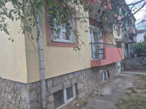 a building that is painted yellow and pink at Apartment "Daisy Flower" - Center, Bitola in Bitola