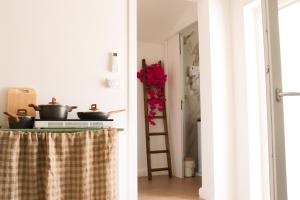 a kitchen with a table with pots and pans on it at Palazzo Donnamaria in Manfredonia +50 photos