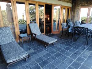 a patio with chairs and a table on a patio at Mafuta Lodge - Mabalingwe Nature Reserve in Warmbaths