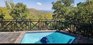 a small swimming pool with a fence and trees at Mafuta Lodge - Mabalingwe Nature Reserve in Warmbaths +11 photos