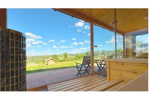 a screened in porch with a view of the mountains at Csenger Vendégházak in Mátraverebély