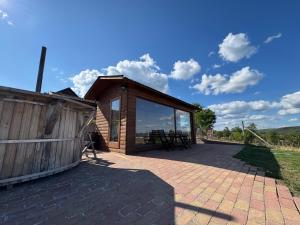 a house with a large patio with a wooden building at Csenger Vendégházak in Mátraverebély