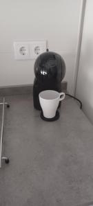 a coffee maker and a white bowl on a counter at El Rincón de Perez B in Ajo