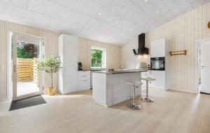 a kitchen with white cabinets and a counter top at Nice Home In Hemmet With Wifi in Falen