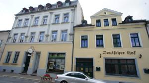 a building with a car parked in front of it at Deutscher Hof in Plauen