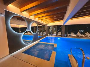 a swimming pool in a hotel with a building at Vila Pozitiv in Sisevac