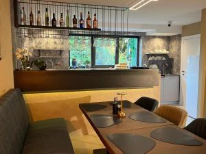 a kitchen with a table and some bottles on the wall at Vila Pozitiv in Sisevac
