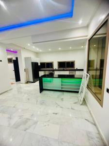 a large room with a large white tile floor at Villa Itran Marrakech in Aguelmous +13 photos