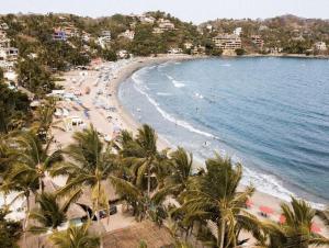 a view of a beach with palm trees and the ocean at Florence Sayulita in Sayulita