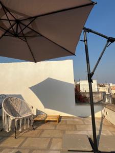 an umbrella sitting on a patio with a bench at AHeritage 5 in Marittima