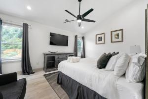 a bedroom with a large bed with a ceiling fan at Welcome Home! in Lawrenceville