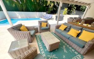 a patio with wicker furniture next to a pool at ZenBreak Jack's Place 3bd in Saint Peter