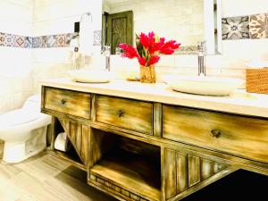 a bathroom with two sinks and a toilet at ECOTICA Boutique Hotel in Manuel Antonio