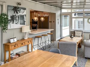 a kitchen and living room with a table and chairs at Rosedale in Benllech +28 photos
