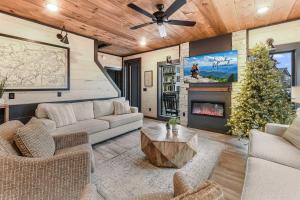 a living room with a couch and a fireplace at Smith Creek Resort - 5 Bedrooms 20 Guest - Indoor Pool - Resort Amenities in Pigeon Forge