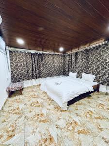 a bedroom with a large bed with a stone floor at Tony apartment baga in Baga +48 photos