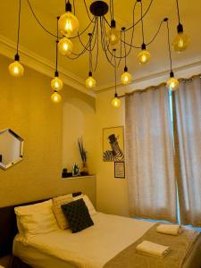 a bedroom with a bed and a window with lights at BoHo BreeZe Rooms in Brighton & Hove