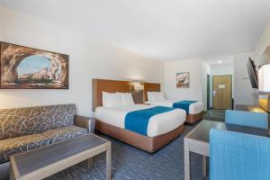 a hotel room with two beds and a couch at Best Western Inn of Payson in Payson +32 photos