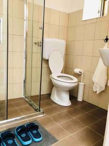 a bathroom with a toilet and a glass shower at Casa di Sunshine in Ragusa +116 photos