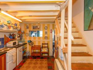 a small kitchen with a staircase in a tiny house at Blue - Uk43119 in Trefor