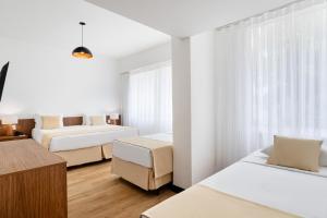 Ένα ή περισσότερα κρεβάτια σε δωμάτιο στο Savoy Othon Lite