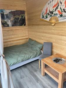 a small room with a bed and a table at Maya Lake House Ponton Bicaz 