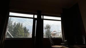 a window with a view of a mountain at Assad Resorts in Srinagar