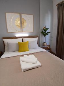 a bed with two towels sitting on top of it at Luxury Spot Xanthi in Xanthi