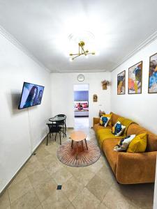 a living room with a couch and a table at TerraKota Cosy T2 au cœur d'Evry Courcouronnes in Evry-Courcouronnes