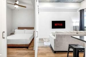 a bedroom and living room with a bed and a couch at Modern Channelside 1BD Apartment | Close to DT! in Tampa +17 photos