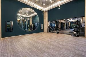 a gym with a large room with a large mirror at Modern Channelside 1BD Apartment | Close to DT! in Tampa