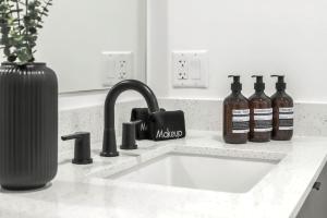 a kitchen counter with a sink and bottles of alcohol at Downtown Ybor Studio Escape Free Pool in Tampa +8 photos