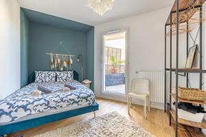 a blue bedroom with a bed and a chair at Paris Gem, Modern 2 Bedroom with Terrace, Parking and Metro Access in Bagnolet